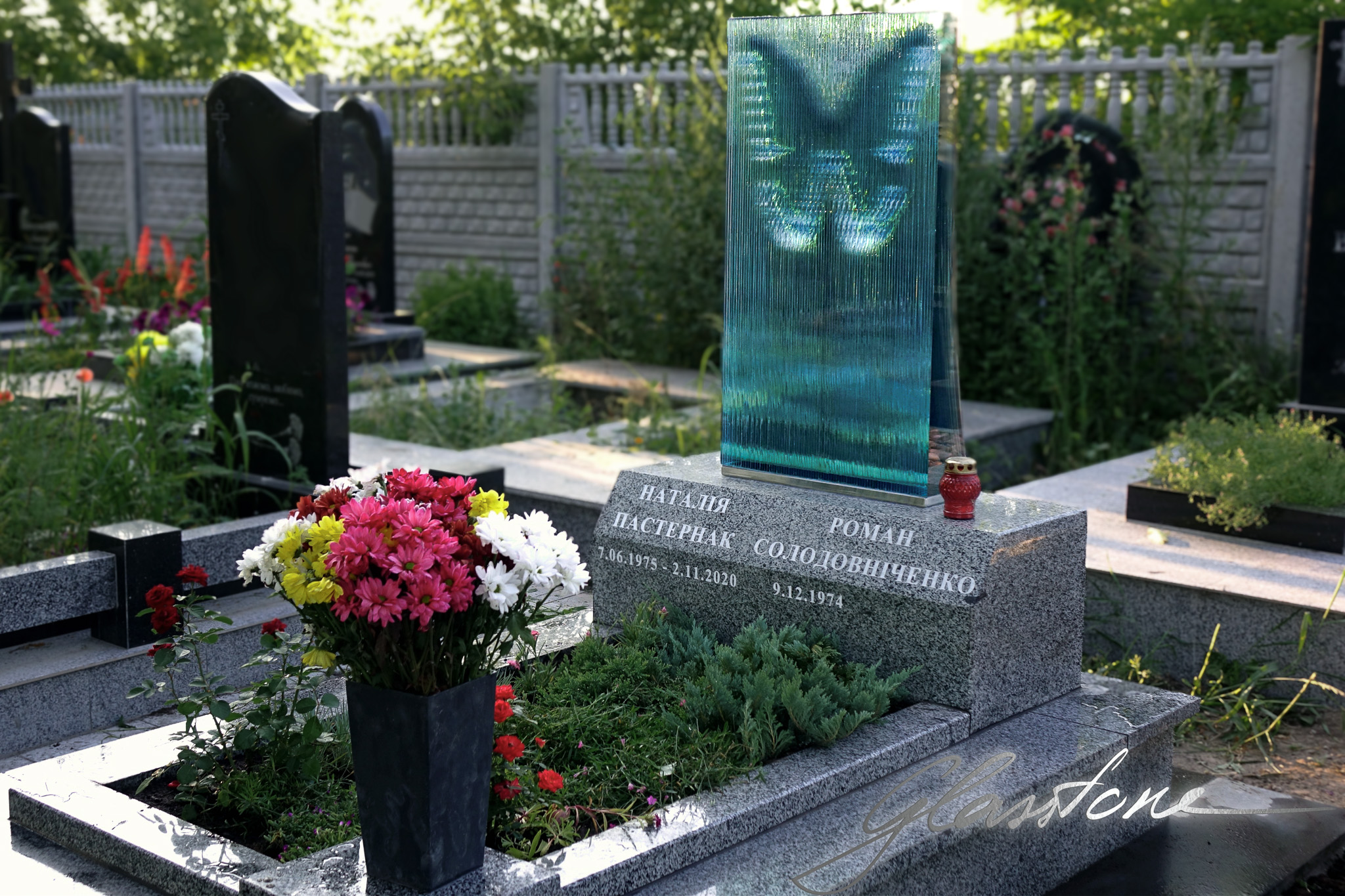 beautiful headstone for wife, combined glass grave monument for a woman in a form of a butterfly, beautiful commemorative grave monument butterfly, memorial butterfly in glass and granite. Feminine headstone for a wife